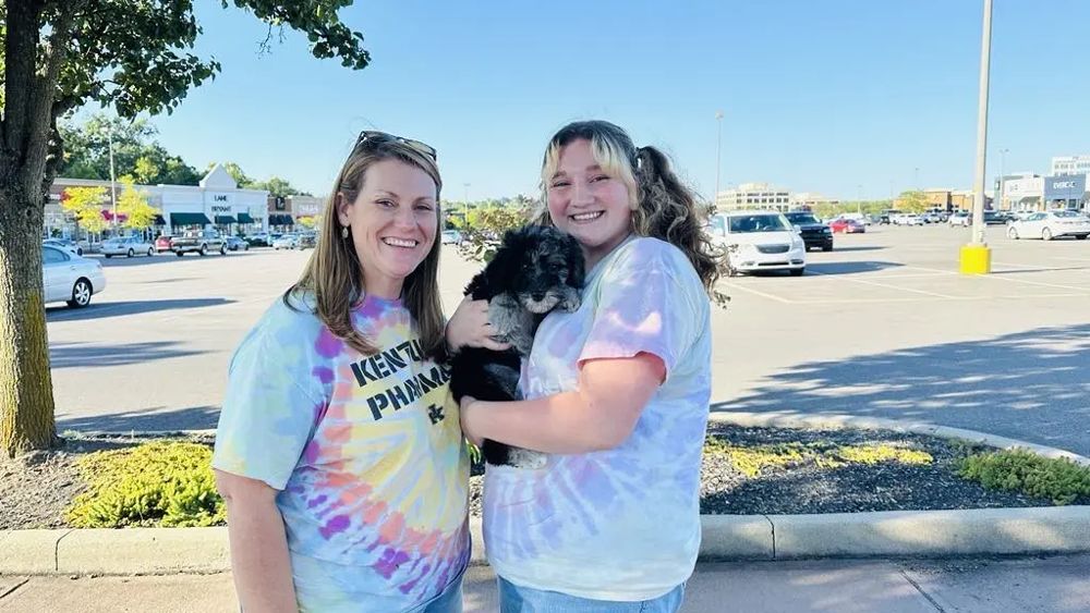 The Tai Kidwell Hieneman family with Bernedoodle